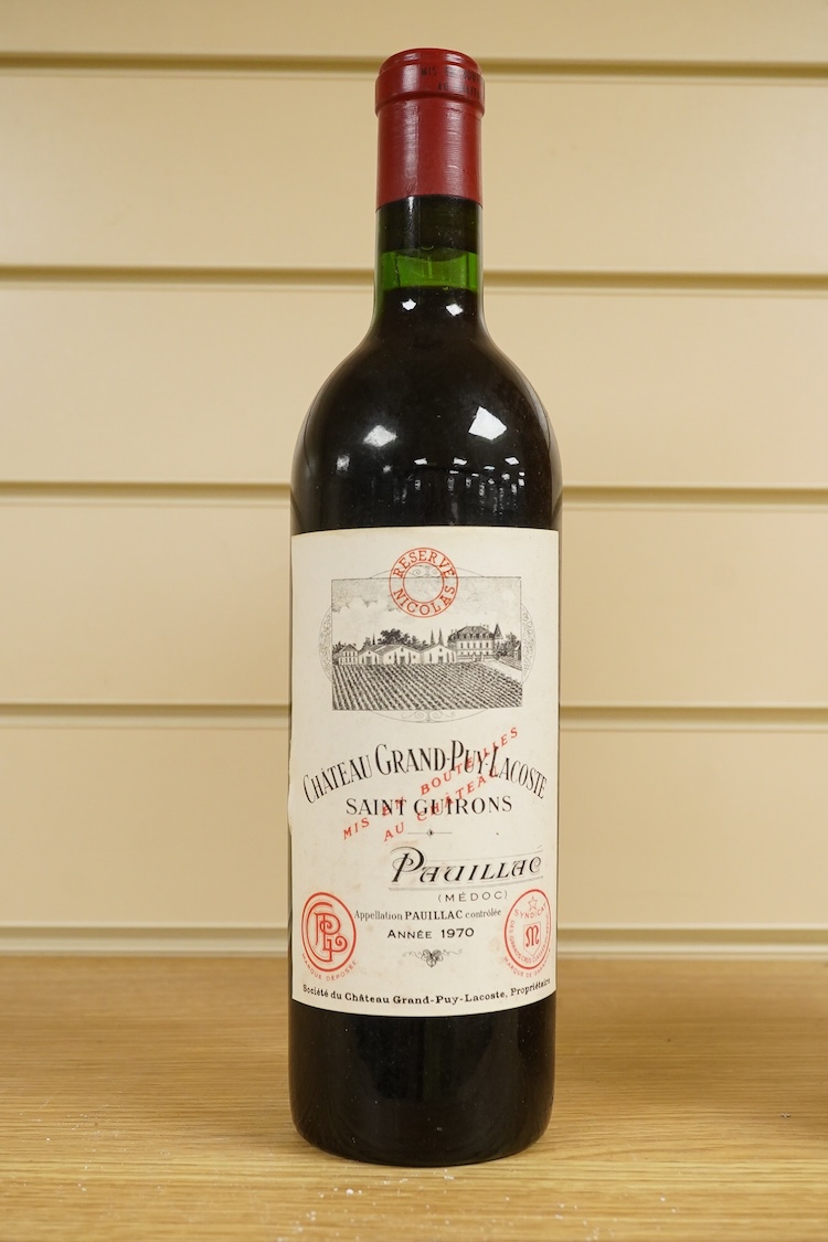 A bottle of Fonseca 1970 vintage port, a bottle of 1970 Chateau Grand-Puy-Lacoste, a litre bottle of Bounty rum and a litre bottle of Harvey’s Bristol Cream